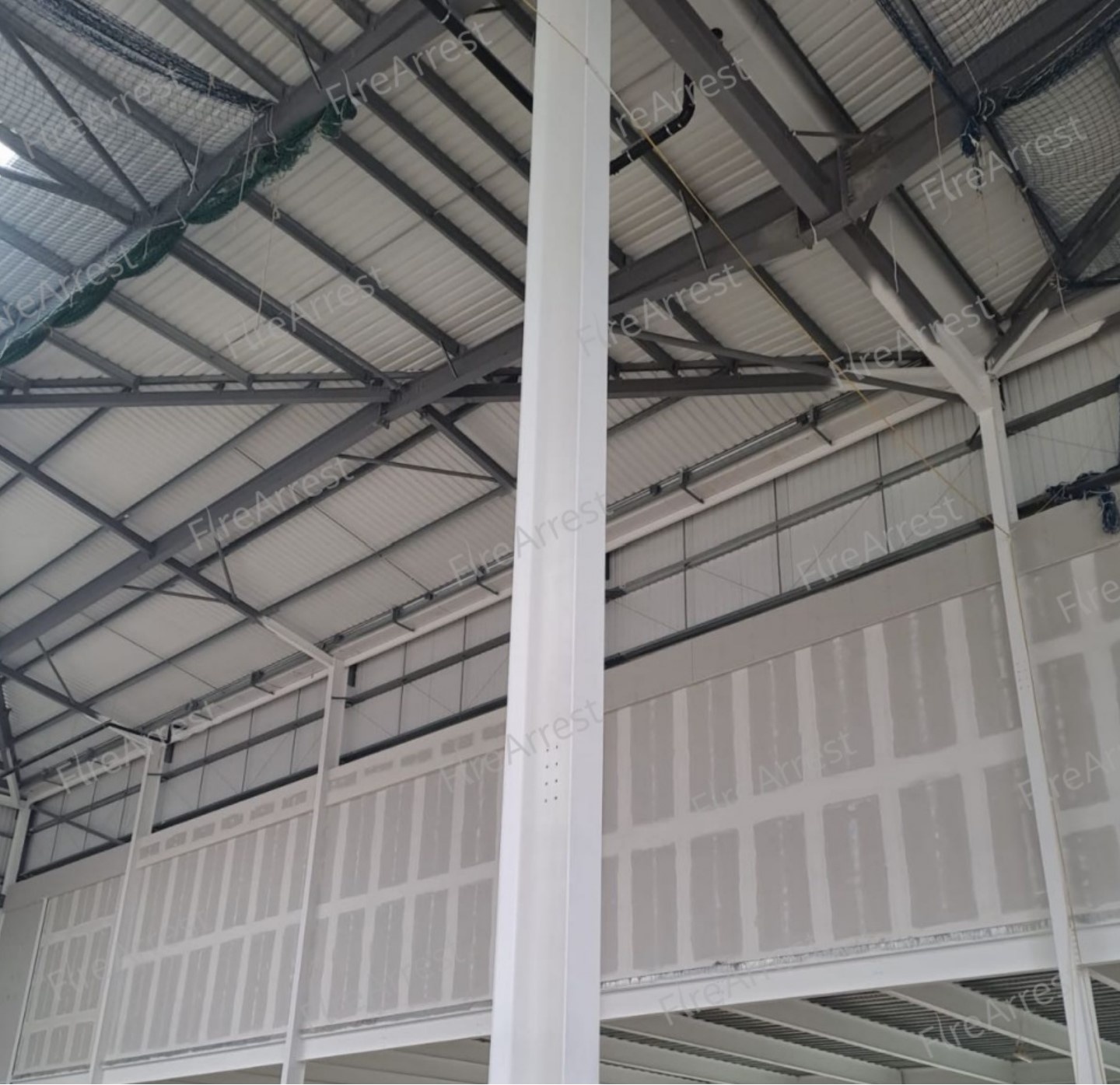 Intumescent-coated structural steel beams inside a building