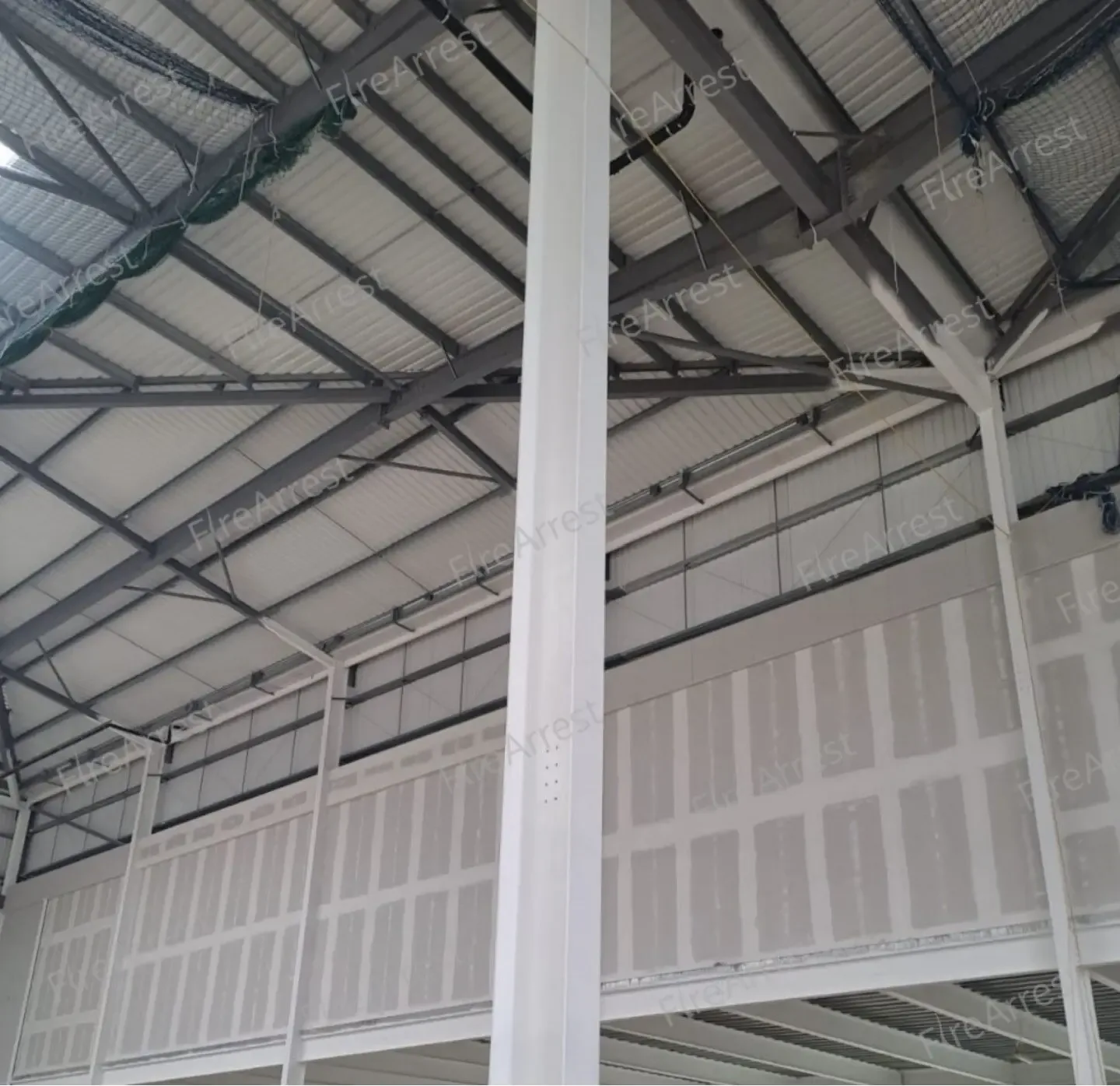 Intumescent paint structural steel — Manchester, Ancoats M1: white-coated steel columns and beams inside a warehouse.