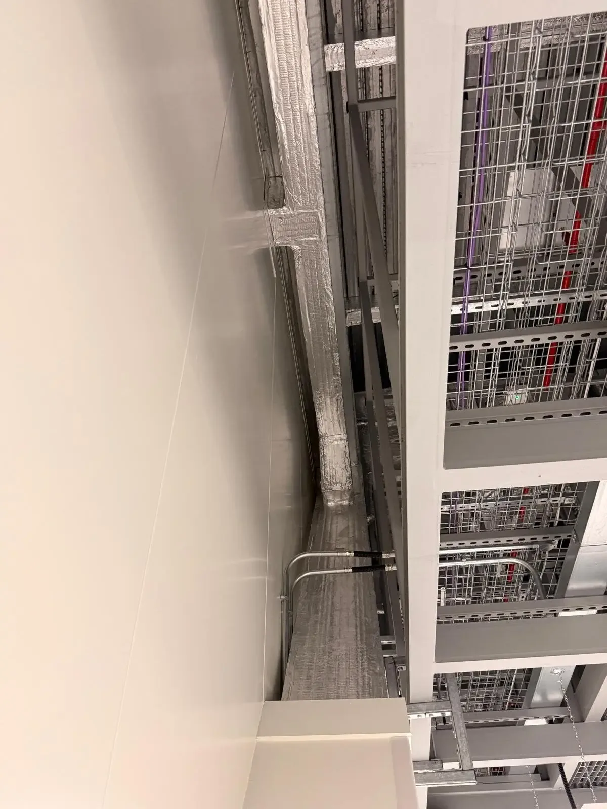 Service penetration fire stopping — Manchester, Wythenshawe M22: high-level cable containment and service routes.