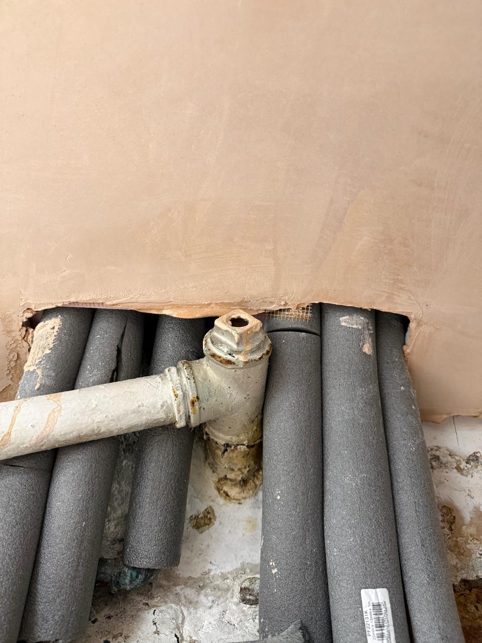 Open pipe penetrations through a compartment wall requiring fire stopping